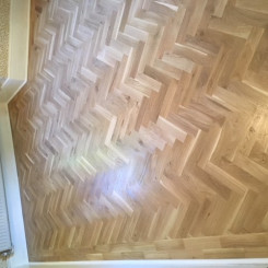 Rustic Oak Blok Flooring – laid in herringbone design with two strip border.